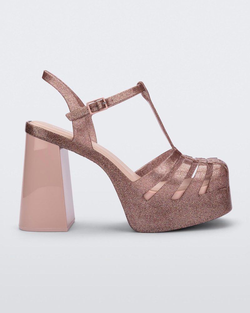 Side view of a pink glitter Melissa Party platform heel.