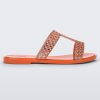 Side view of an orange / copper Melissa Glowing slide with copper gem stones on the straps and an orange sole.