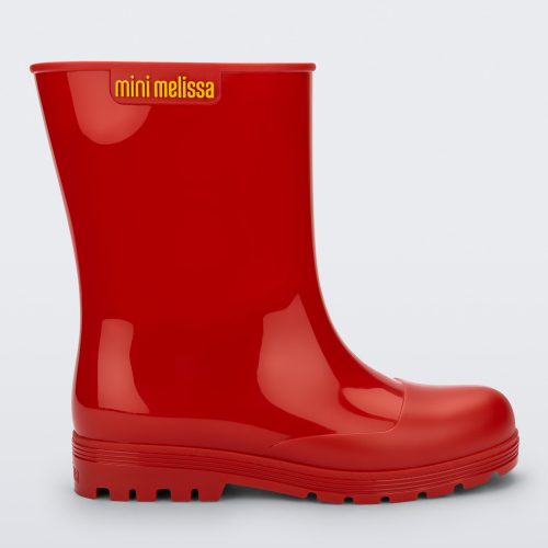 Side view of a red kids Melissa Welly boot.