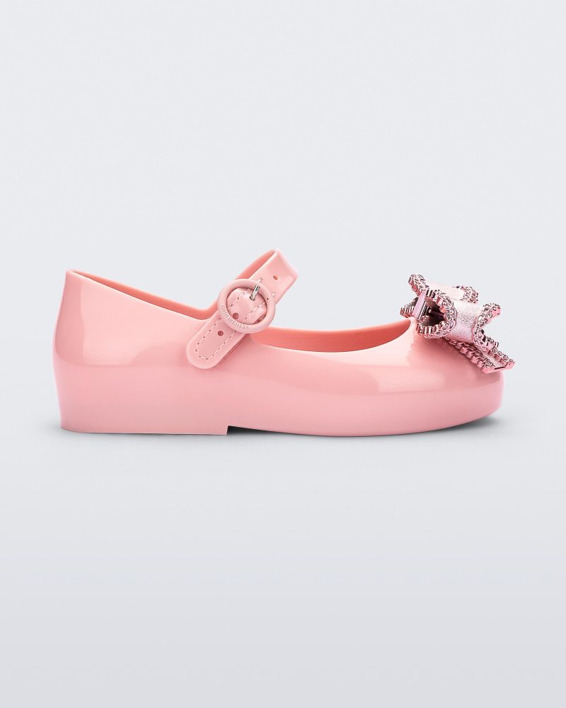 Side view of a pink Mini Melissa Sweet Love baby mary jane flat with a metallic pink bow.