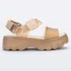 Side view of a beige/gold Melissa platform Kick Off Sandal with two glitter straps.