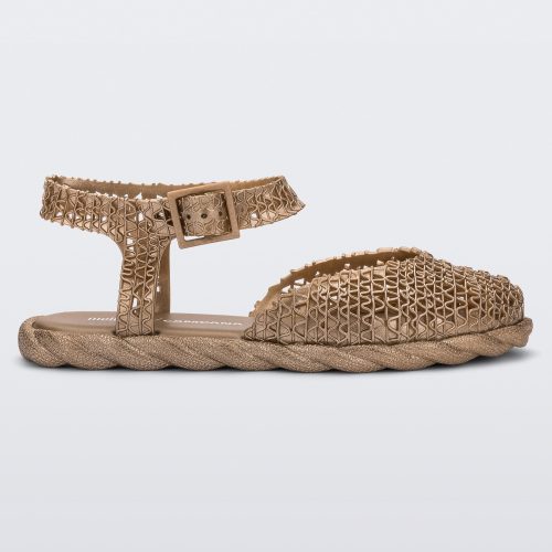 Side view of a gold Melissa Papel Espadrille Campana sandal with braided sole detail and ankle strap