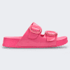 An outer side view of a pink Melissa Cozy slide on a gray background