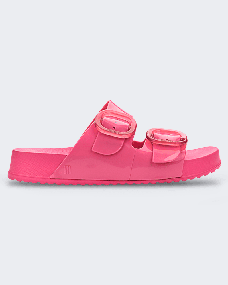 An outer side view of a pink Melissa Cozy slide on a gray background