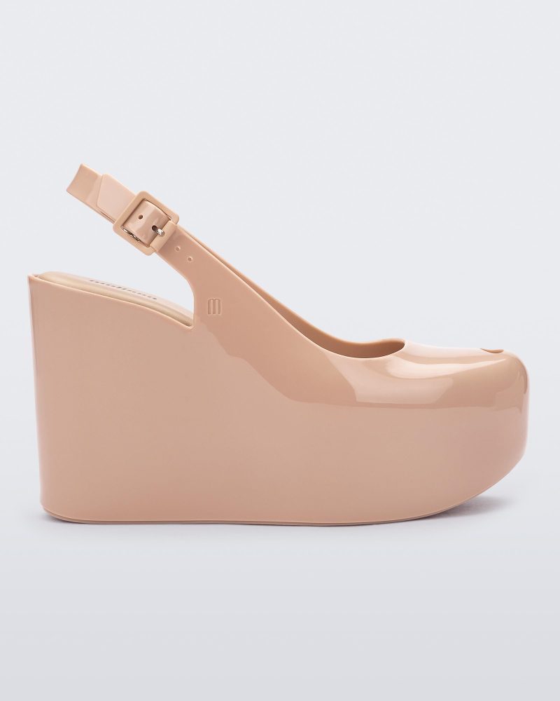 Side view of a beige Melissa Groovy wedge platform slingback heel with peep toe.