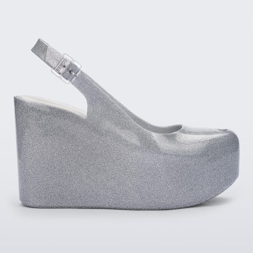 Side view of a clear glitter Melissa Groovy wedge platform slingback heel with peep toe. 