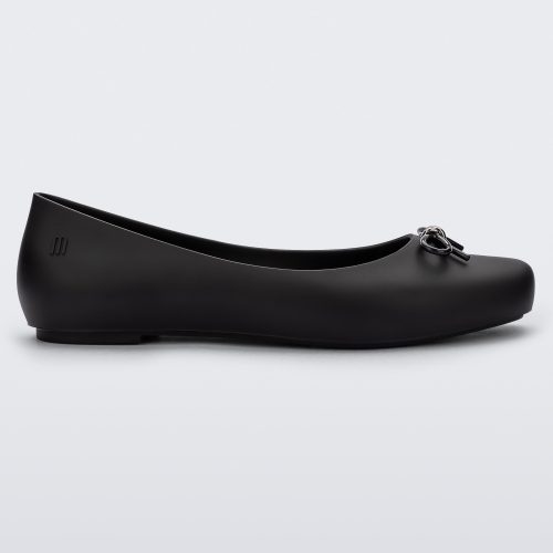 Side view of a black Melissa Aura Basic flat with a black bow.