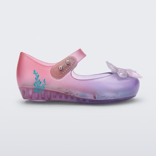 Side view of a transparent pink and purple Mini Melissa Ultragirl + Disney Little Mermaid flat with a pearly white flower on top