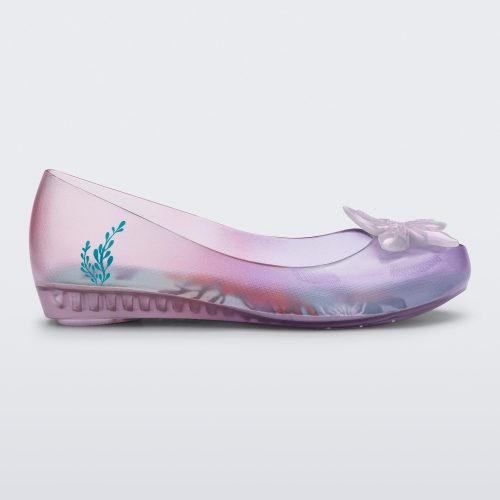 Side view of a clear pearly pink and purple Mini Melissa Ultragirl + Disney Little Mermaid flat with a pearly purple flower.