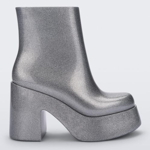 Side view of the silver glitter Melissa Nubia platform heel boot.