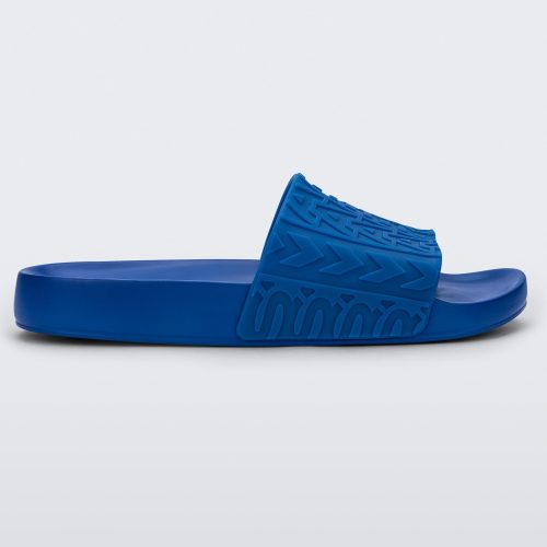 Side view of a blue Melissa Slide with the marc jacob's logo across the front strap.