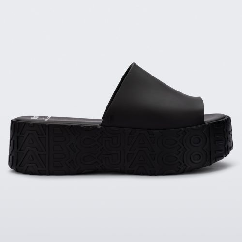 Side view of a black Melissa Becky platform slide with the marc jacobs logo across the sole.