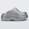 Side view of a silver Melissa Clog with the Marc Jacob's logo across the sole.