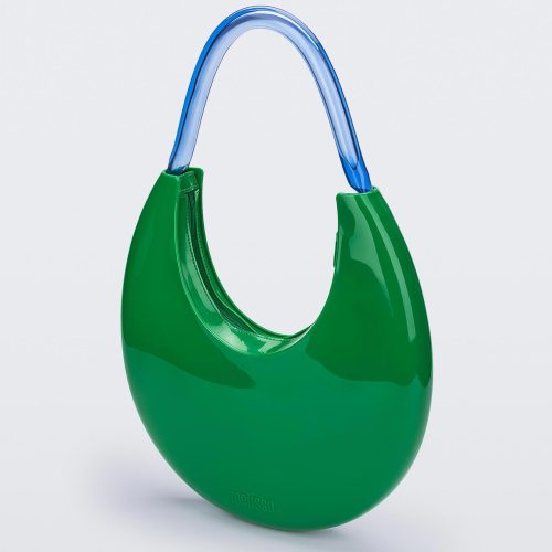 An angled front view of a Green/Blue Melissa Moon Bag with a crescent shaped green bag base and a blue beige top strap.