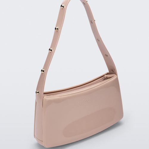 Angled view of the pink Melissa Baguete Studs bag with a short studded strap.