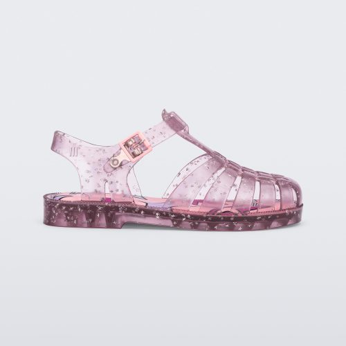 Side view of a clear pink Possession kids sandal with star glitter