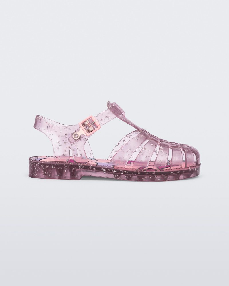 Side view of a clear pink Possession kids sandal with star glitter