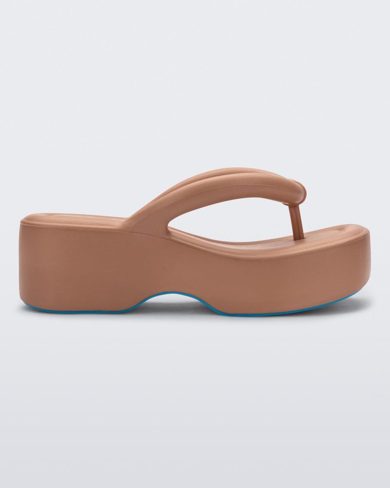 Side view of a Melissa Free platform flip flop in brown with blue sole