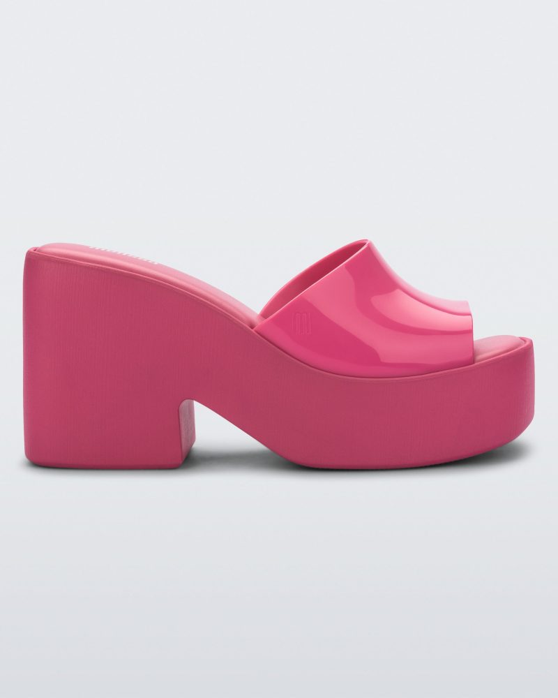 Side view of a Melissa Posh platform slide in pink