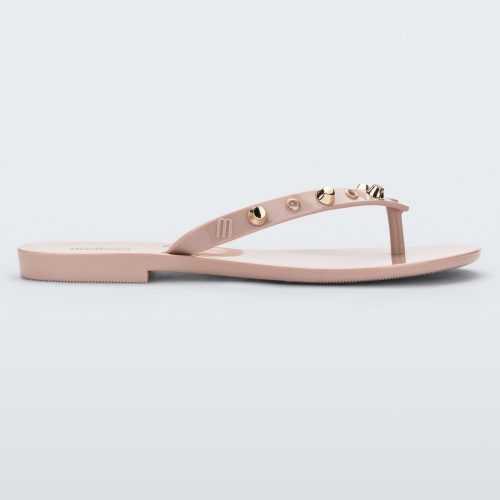 Side view of a pink Melissa Harmonic Studs flip flop with gold studs on the upper.