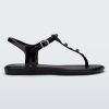 Side view of a black Melissa Solar studs sandal with gold studded t-strap and gold buckle.