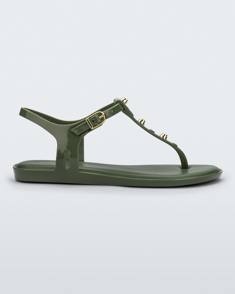 Side view of a green Melissa Solar studs sandal with gold studded t-strap and gold buckle.