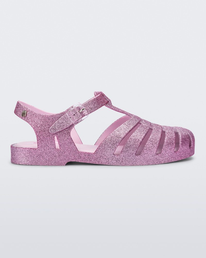 Side view of a pink glitter Possession sandal.