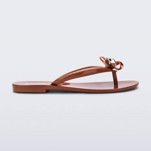 Side view of a brown Harmonic Eclipse flip flop with bow.