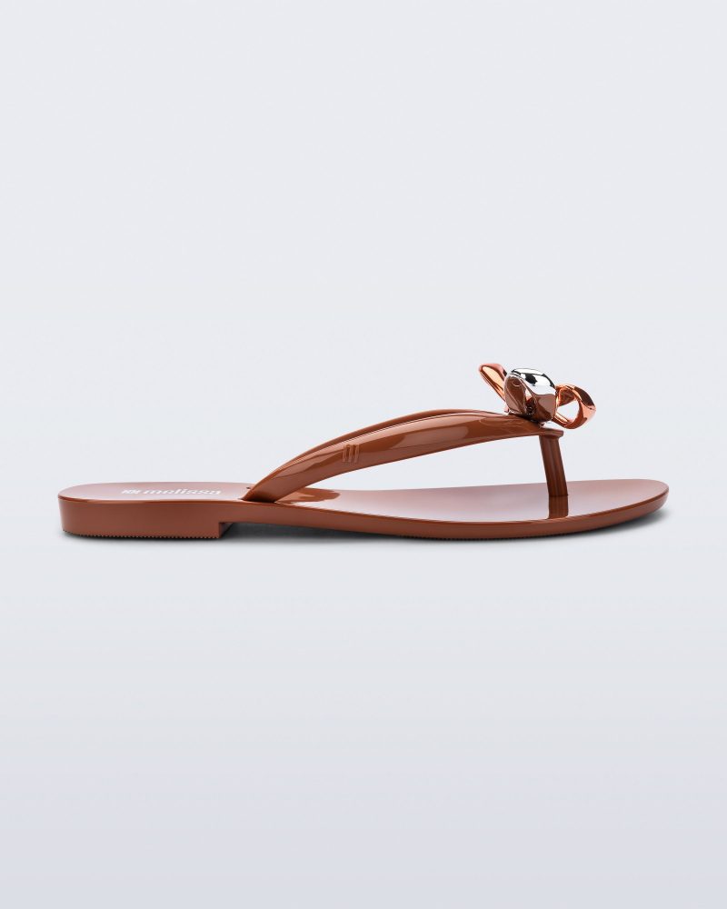 Side view of a brown Harmonic Eclipse flip flop with bow.