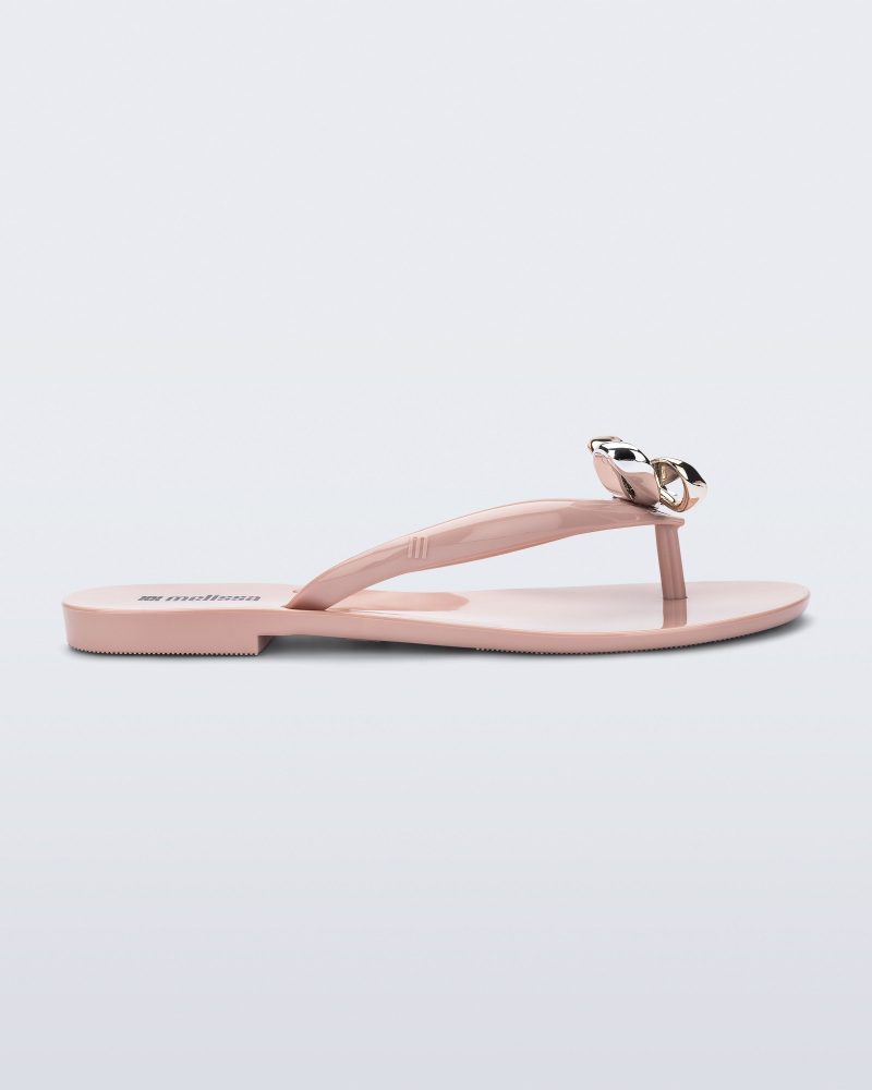 Side view of a pink Harmonic Eclipse flip flop with bow.