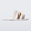 Side view of a white Eclipse Slide with bronze straps.