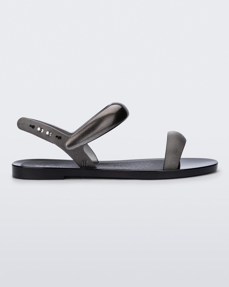 Side view of a black Eclipse Sandal with silver straps.