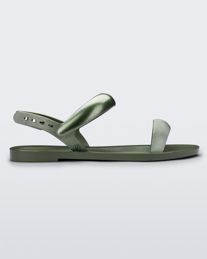 Side view of a green Eclipse Sandal with glitter green straps.