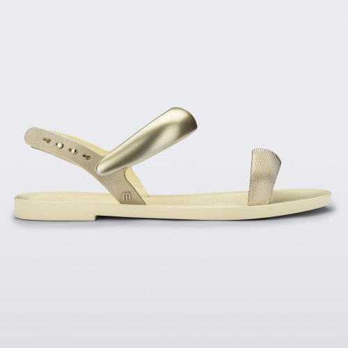 Side view of a beige Eclipse Sandal with gold straps.