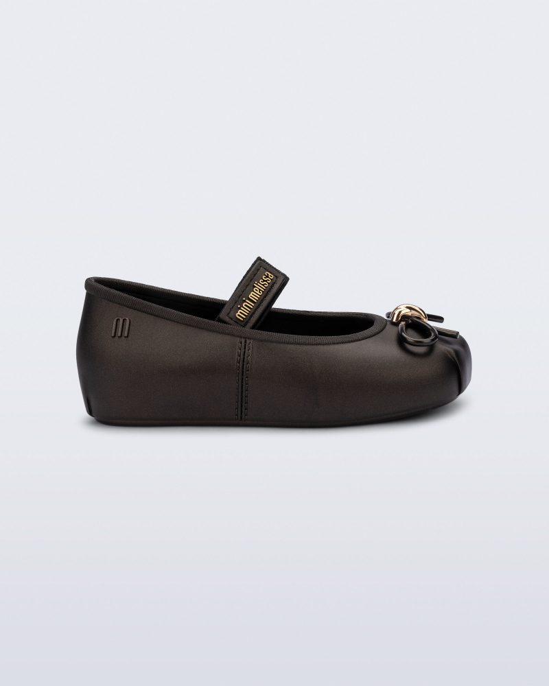 Side view of a metallic black Sophie baby ballerina flat with bow