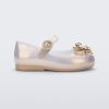 Side view of a pearly gold Mini Melissa Sweet Love Butterfly flat with a top strap and a gold butterfly detail on the toe