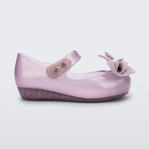 Side view of a pink glitter Ultragirl Sweet baby ballerina flat with bow