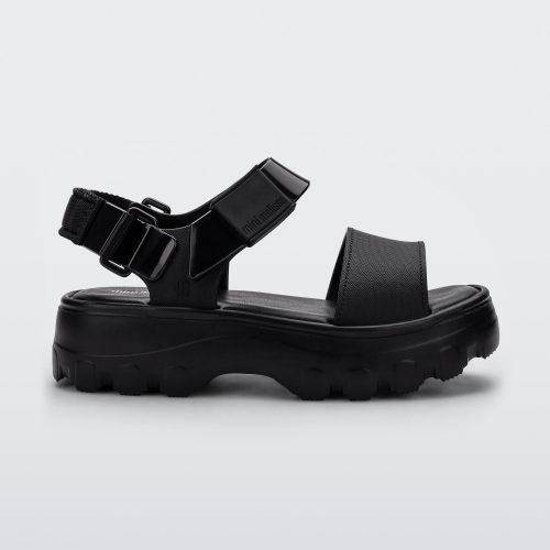 Side view of a Mini Melissa Kick Off platform sandal in black with adjustable velcro ankle strap.