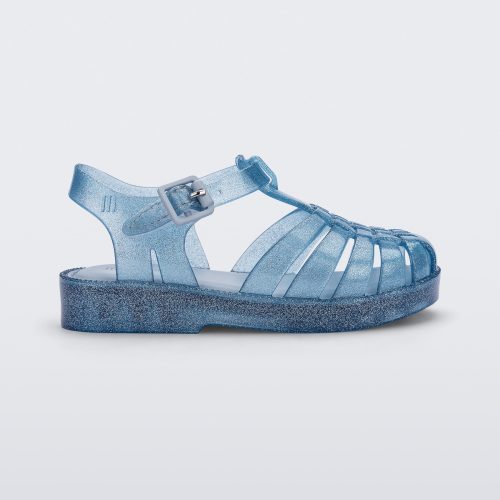 Side view of a Mini Melissa Possession baby sandal in glitter blue with velcro buckle closure on the ankle strap