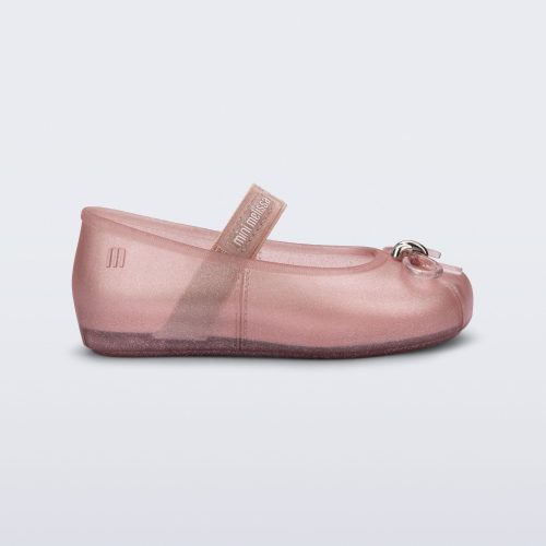 Side view of a pearly pink Sophie baby ballerina flat with bow