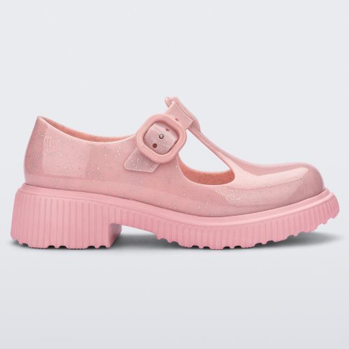 Side view of a Pink Mini Melissa Jackie loafer with a pink glitter base, two cut outs, a pink buckle detail strap and pink sole.