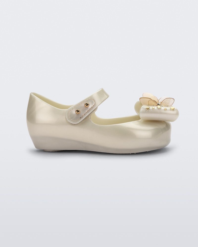 Side view of a Mini Melissa Ultragirl peeptoe ballet flat  for baby in white with star printed butterfly bow applique.