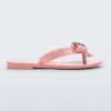 Side view of a pink Mini Melissa Harmonic Heart flip flop with a pink bow and metallic pink heart detail on the straps