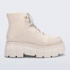 Side view of a beige Rebel boot with laces