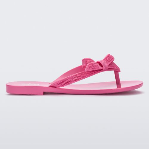 Side view of a pink Harmonic M Lover adult flip flop with Melissa logo on strap