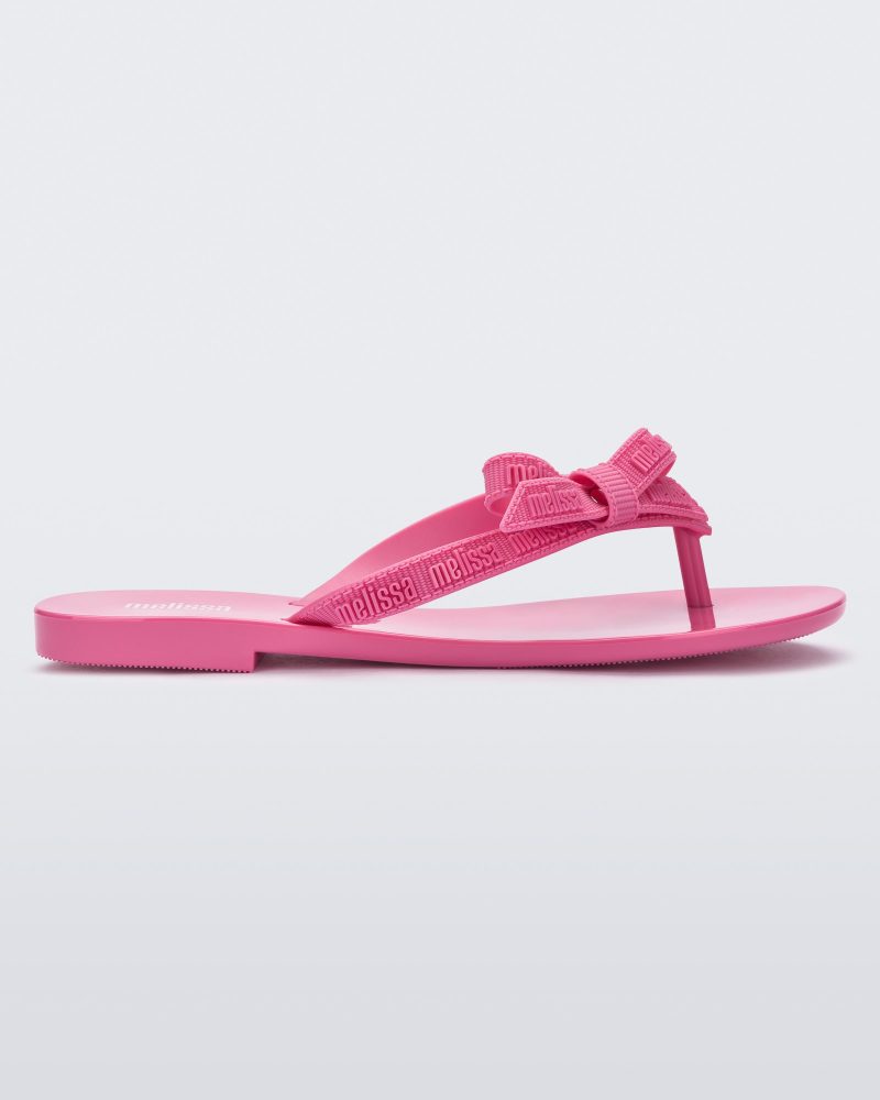 Side view of a pink Harmonic M Lover adult flip flop with Melissa logo on strap