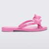 Side view of a Pink Melissa Slim flip flop with a bow detail on the front straps.