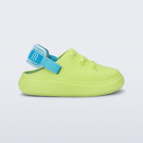 Side view of a green with blue back strap Charlie baby sneaker