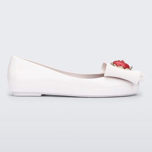 Side view of a white Sweet Love Snow White kids flat with a white bow with red apple center