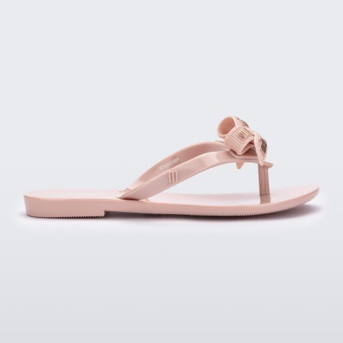 Side view of a light pink Harmonic M Lover kids flip flop with Melissa logo on bow